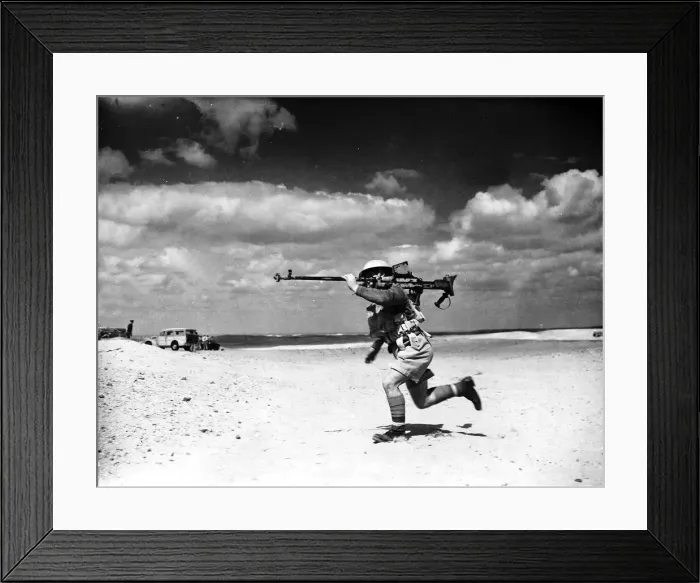 Framed Print : A British soldier jogging through the desert in Egypt with a Boyes anti-tank rifle over