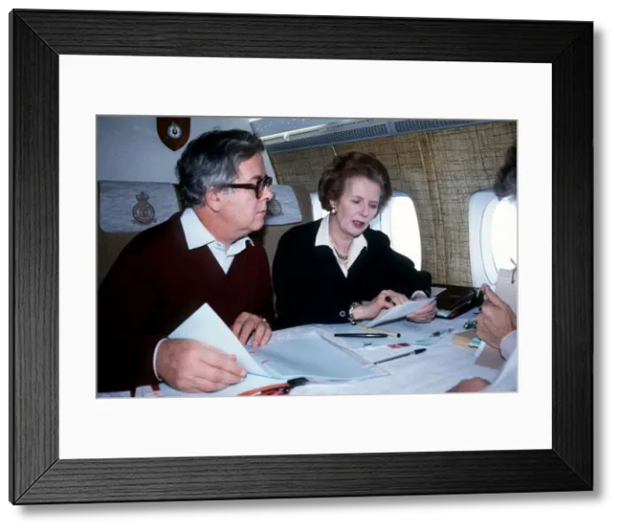 Framed Print : Margaret Thatcher MP prime Minister with Geoffrey Howe MP sit on a plane on their way to Framed Print : Margaret Thatcher MP prime Minister with Geoffrey Howe MP sit on a plane on their way to