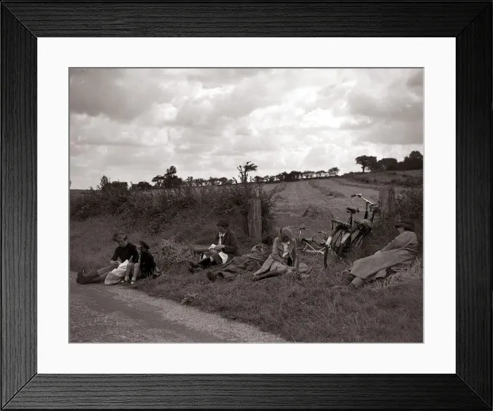 Framed Print : A family of cyclists enjoying a break from their journey into the countryside