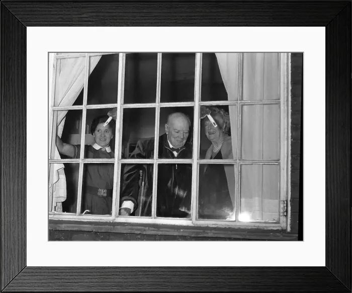 Framed Print : Sir Winston Churchill MP stands looking out of a window with his wife Framed Print : Sir Winston Churchill MP stands looking out of a window with his wife