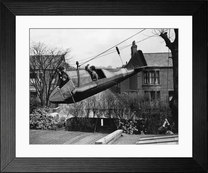 Framed Print : Audrey Alma and Billie Disberry playing in a 14ft model bomber in their back garden