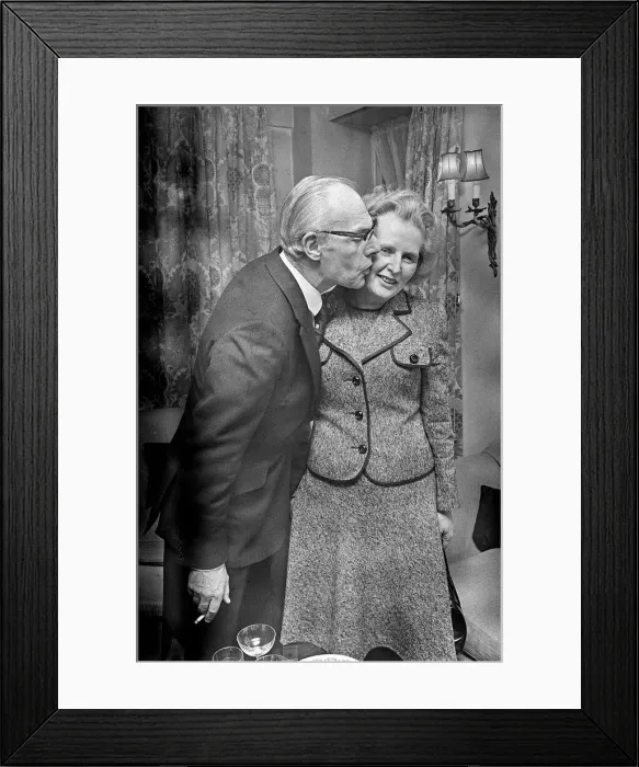 Framed Print : Margaret Thatcher with Denis Thatcher who kisses her on the cheek - February 1975 Framed Print : Margaret Thatcher with Denis Thatcher who kisses her on the cheek - February 1975