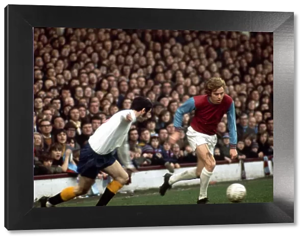 Harry Redknapp of West Ham United in a chase for the ball with John Robson of Derby