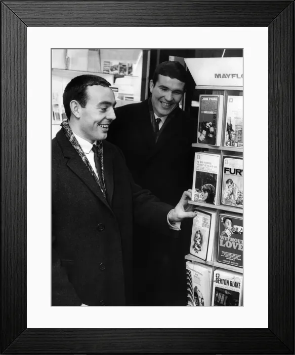 Framed Print : Liverpool football players Ian St. John and Ron Yeats at a bookstall waiting to fly to Framed Print : Liverpool football players Ian St. John and Ron Yeats at a bookstall waiting to fly to