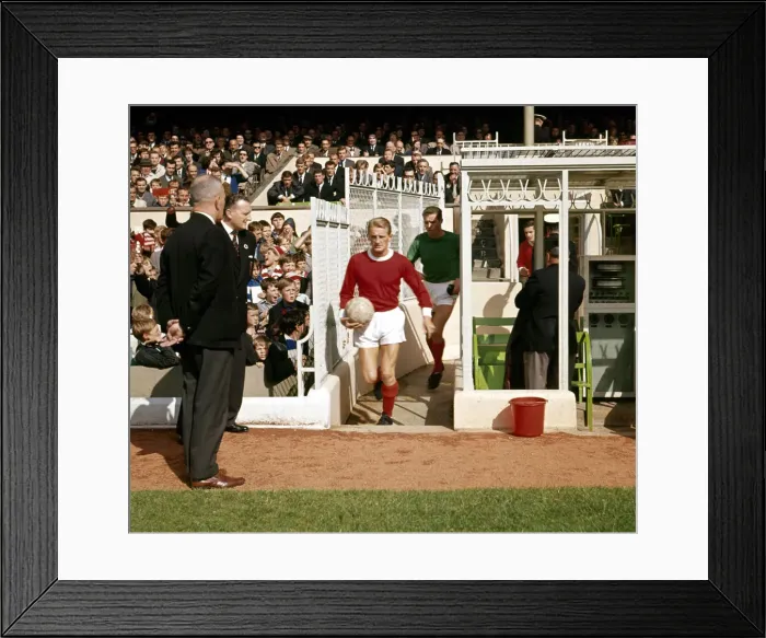 Framed Print : Bobby Charlton leads the Manchester United team out for a league division one match Framed Print : Bobby Charlton leads the Manchester United team out for a league division one match