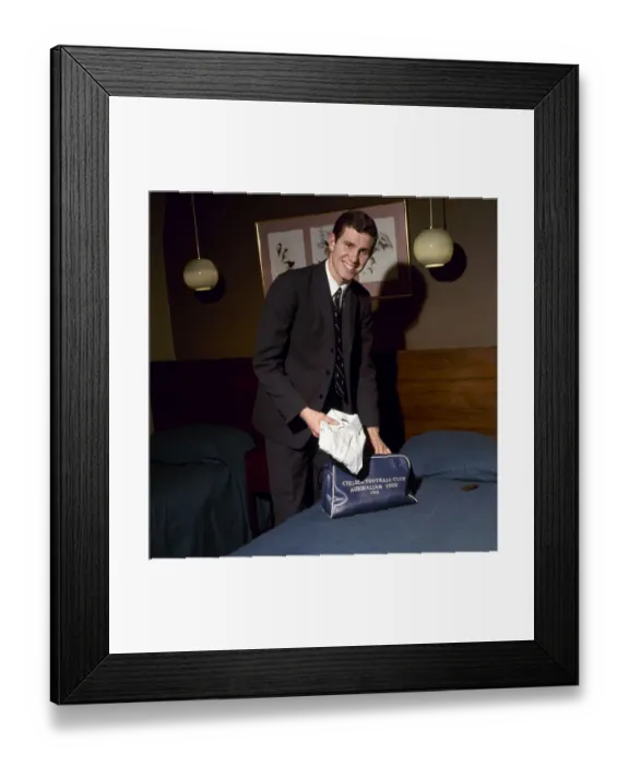 Framed Print : Chelsea footballer Peter Osgood in a hotel room packing his bag February 1966