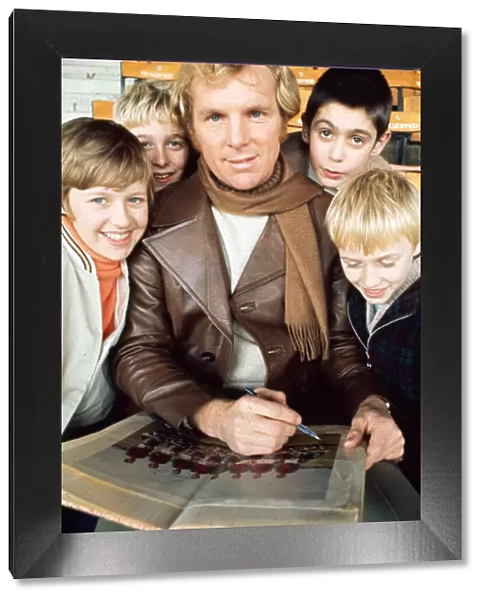 West Ham United footballer Bobby Moore modelling a leather coat with scarf February