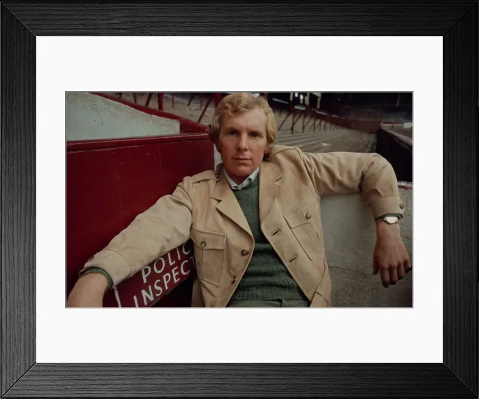 Framed Print : West Ham United footballer Bobby Moore modelling a belted raincoat at Upton park Framed Print : West Ham United footballer Bobby Moore modelling a belted raincoat at Upton park
