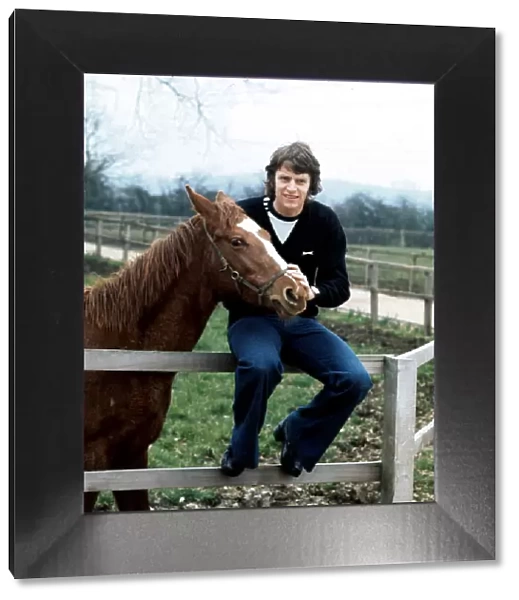 Southampton footballer Mick Channon pictured with one of his racehorses at his farm