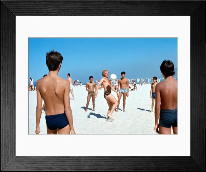 Framed Print : West Ham United and England footballer Bobby Moore with children playing football