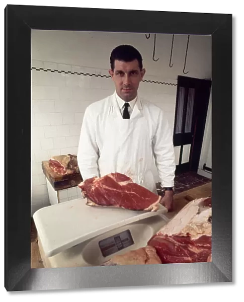English referee jack Taylor weighing a joint of meat in his job as a butcher May