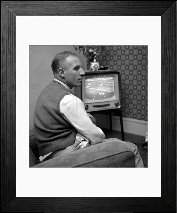 Framed Print : Tottenham Hostpur footballer Eddie Bailey at home watching a match on the television