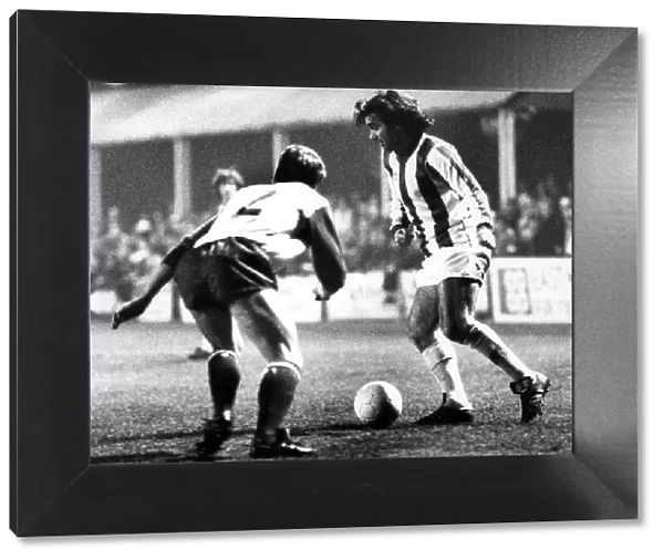 George Best takes on Jim Melrose in a first-half move during the Nuneaton Borough charity