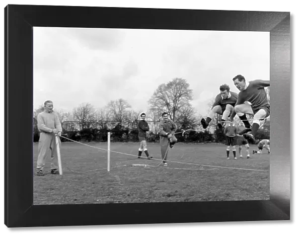 Tottenham Hotspur players Terry Dyson and Les Allen jumping over the rope in training at