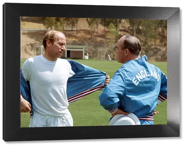 England manager Alf Ramsey talks with Bobby Charlton during a training session with