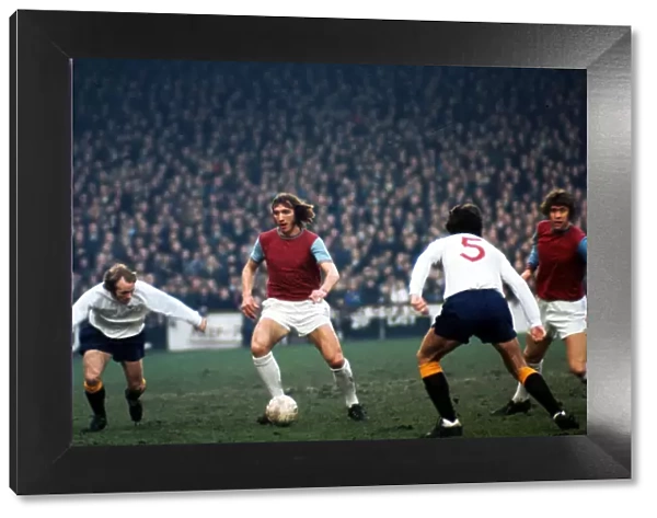 Billy Bonds of West Ham United in a battle for the ball with Archie Gemmill of Derby