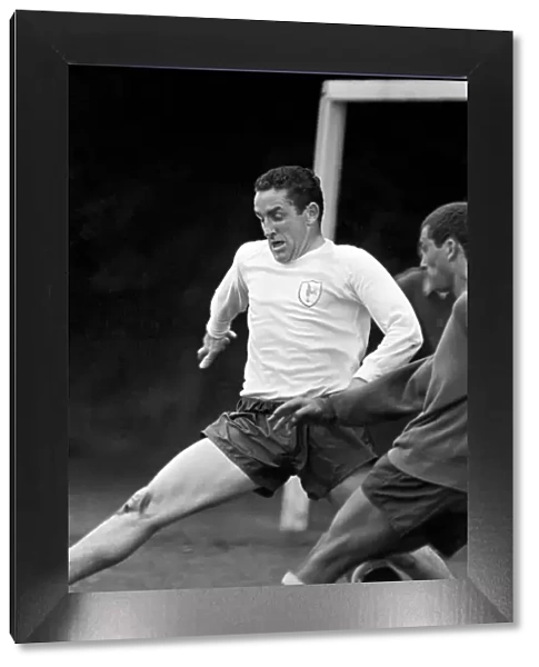 Members of the Tottenham Hotspur team training. Dave Mackay practices his tackling