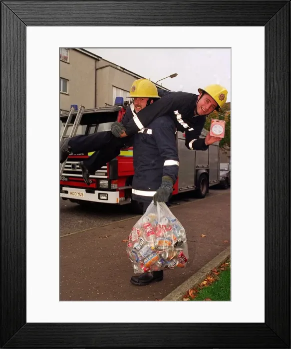 Framed Print : Rangers football player Ally McCoist as a fireman with a smoke alarm in one hand getting