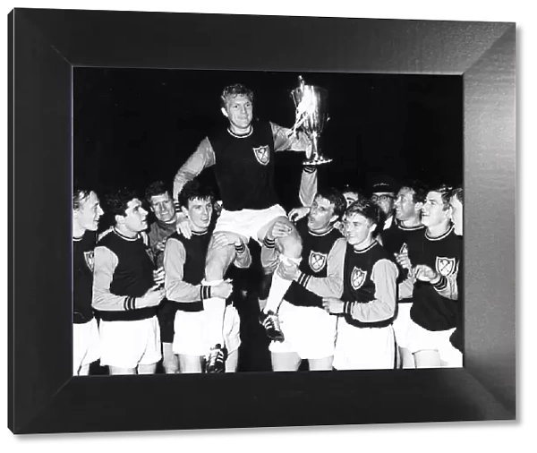 Bobby Moore captain of West Ham United 1965 with teammates after winning