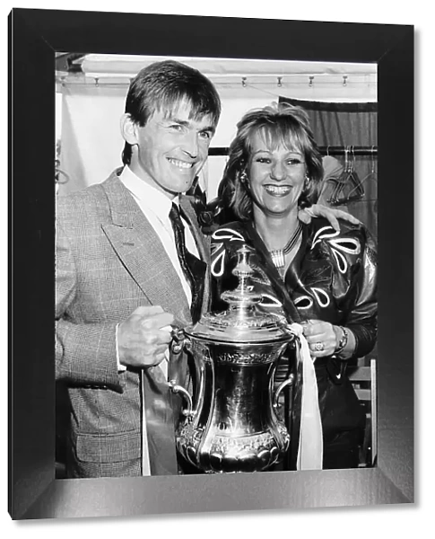 Liverpool player manager Kenny Dalglish holding the FA Cup trophy with his wife Marina