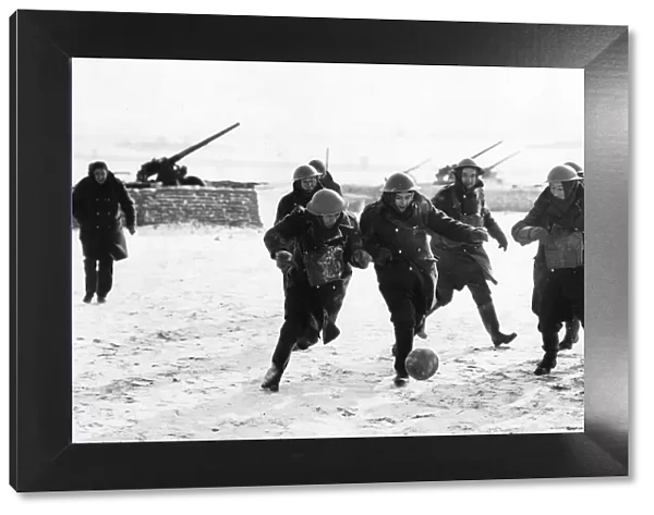 British anti aircraft battery playing football in a snow-covered French field. WW2 1940