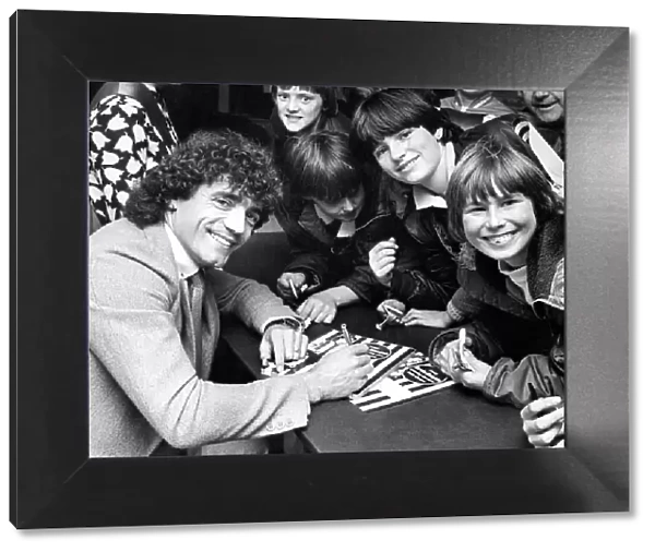 Kevin Keegan signing autographs at the opening of a furniture shop Circa 1983