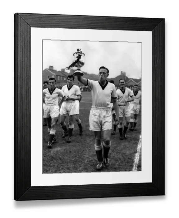 Framed Print : Giant-killersO skipper Frank Marshall holds the beribboned Cup aloft after Framed Print : Giant-killersO skipper Frank Marshall holds the beribboned Cup aloft after