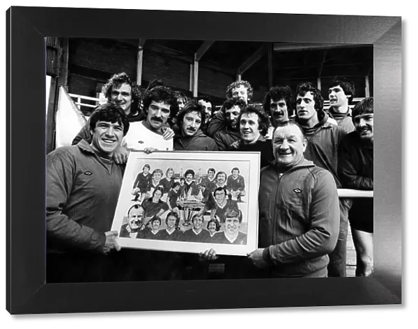 Liverpool football team players holding a photograph of the team