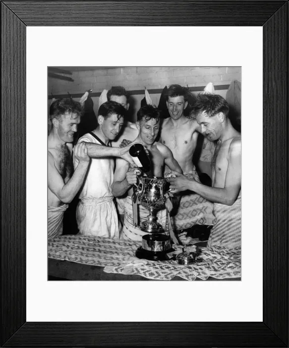 Framed Print : Some of the team fill the Giant Killer Cup with champagne in the dressing room Framed Print : Some of the team fill the Giant Killer Cup with champagne in the dressing room