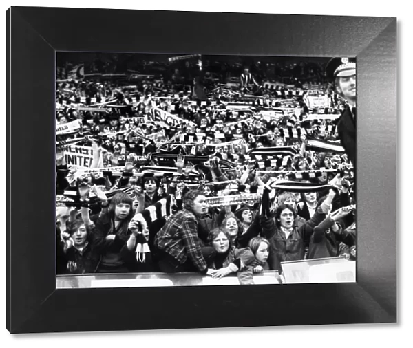 Newcastle United supporters wave their scarves at St James Park before the match
