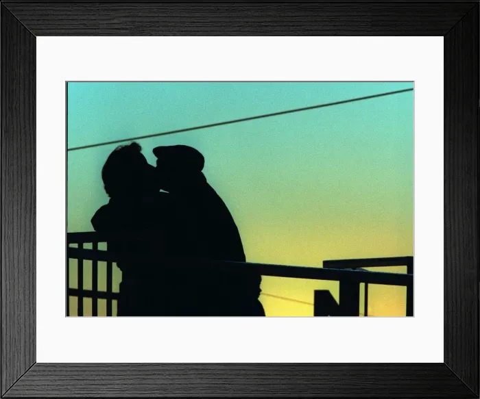 Framed Print : Two lovers kissing find a quiet spot among the crowd at Hamilton game Framed Print : Two lovers kissing find a quiet spot among the crowd at Hamilton game