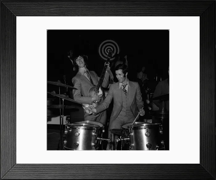 Framed Print : Arsenal footballers George Graham and Charlie George dressed in 1960s style clothing