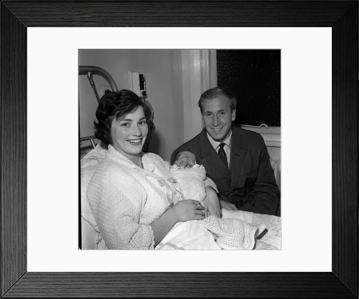 Framed Print : Manchester United footballer Bobby Charlton sits at his wife Framed Print : Manchester United footballer Bobby Charlton sits at his wife
