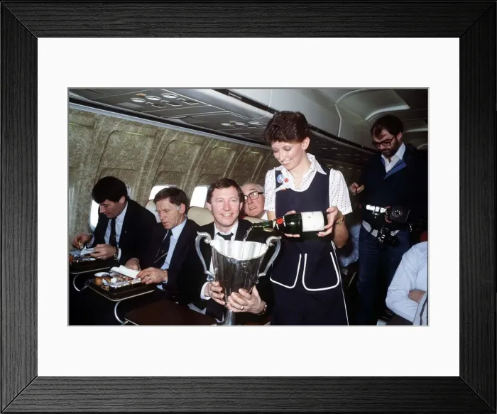 Framed Print : Aberdeen manager Alex Ferguson receives champagne for an air hostess inthe European Cup