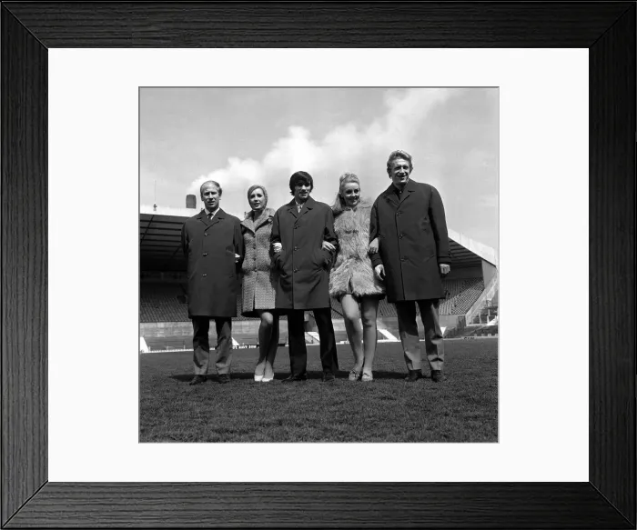 Framed Print : George Best centre with Bobby Charlton and Denis Law 1967 pose with two models at Old Framed Print : George Best centre with Bobby Charlton and Denis Law 1967 pose with two models at Old