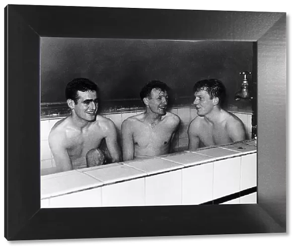 Tony Devreux, Gordon Henry & Dick Renwick of Aldershot FC enjoy a good hot bath