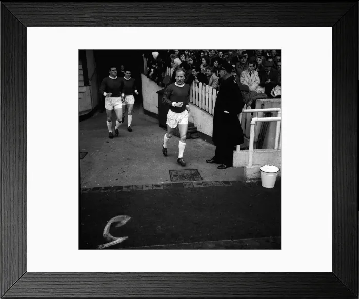 Framed Print : Manchester United footballer Bobby Charlton runs out on to the pitch for the league match Framed Print : Manchester United footballer Bobby Charlton runs out on to the pitch for the league match