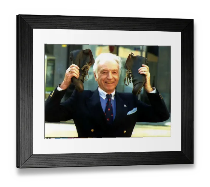 Framed Print : Football legend Sir Stanley Matthews holds up a pair of old fashion football boots in Framed Print : Football legend Sir Stanley Matthews holds up a pair of old fashion football boots in