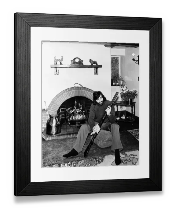 Framed Print : George Best seen here cleaning his gun at home May 1974 Framed Print : George Best seen here cleaning his gun at home May 1974