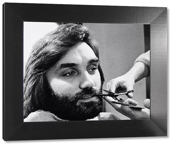 George Bests seen here having his beard trimmed at the barbers May 1974