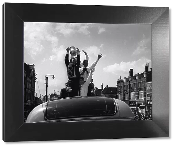 Bobby Moore holds up the FA Cup during the parade around East London after the Hammers