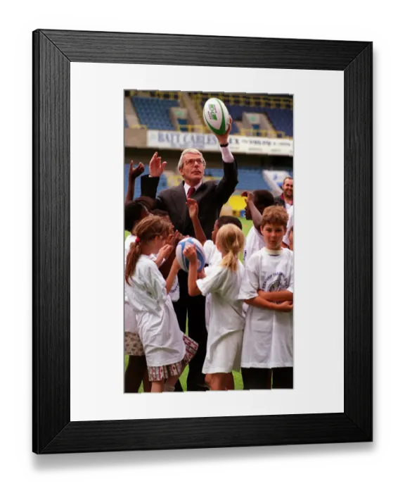 Framed Print : John Major MP Prime Minister tries his hand at the sport with schoolchildren during an