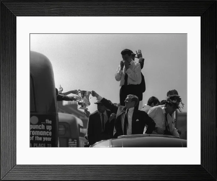Framed Print : Bobby Moore holds up the FA Cup during the parade around East London after the Hammers