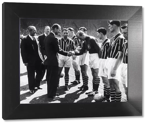 Bert Trautmann of Manchester shakes hands with Prince Philip before the 1956 FA Cup