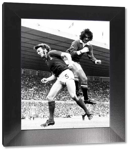 George Best of Manchester United jumps for the ball Aug 1972 against Alan Hunter of