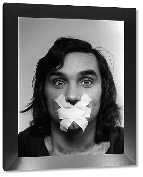 George Best Football player of Manchester United, Mar 1976 with his mouth taped up