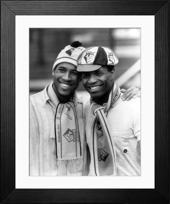 Framed Print : Watford and England duo John Barnes and Luther Blissett pose wearing club hats