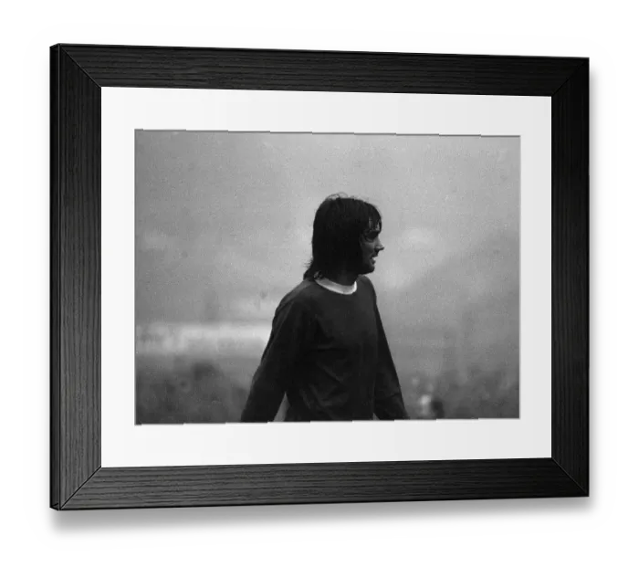 Framed Print : George Best appears out of the mist in the Huddersfield v Manchester United game on a