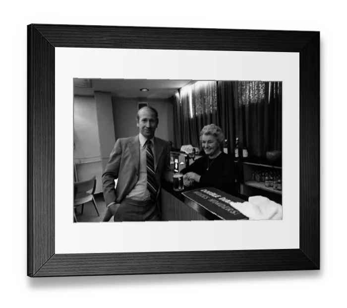 Framed Print : Bobby Charlton enjoys a pint at a bar in the players lounge at Old Trafford