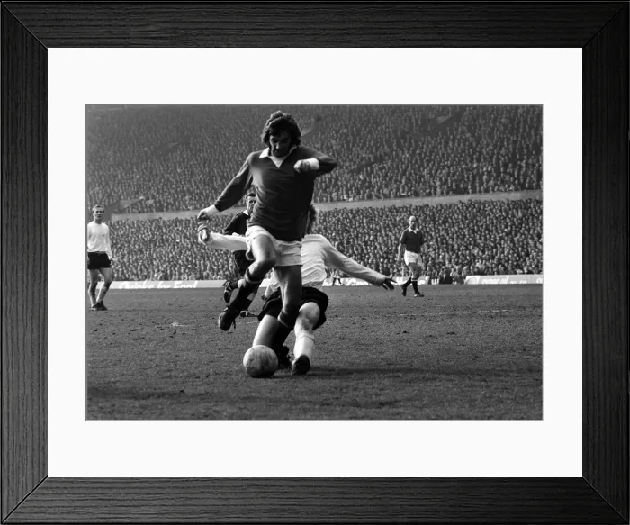 Framed Print : Manchester Uniteds George Best is challenge by Stoke defender March 1972